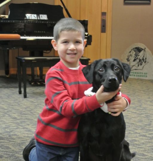A child holding a dog