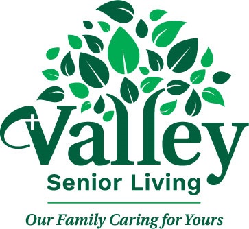 Valley senior living written in green with leaves coming out of the word valley
