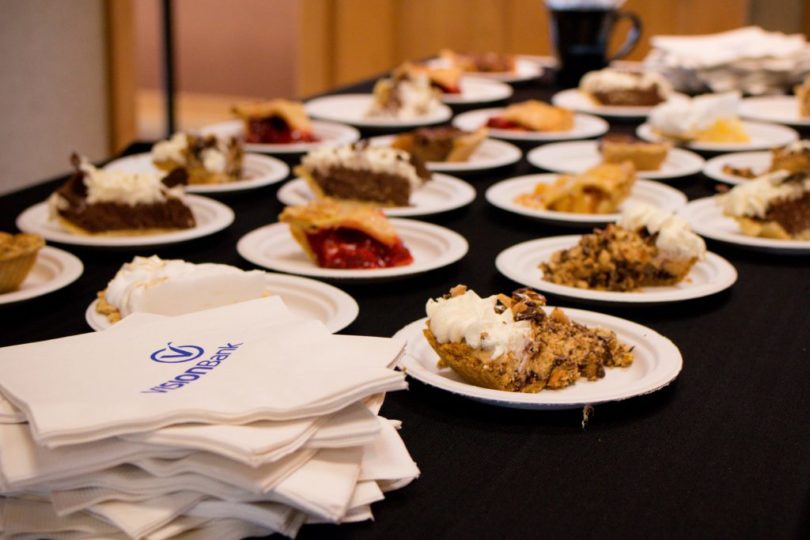 Table with deserts and napkins with the VISIONBank logo