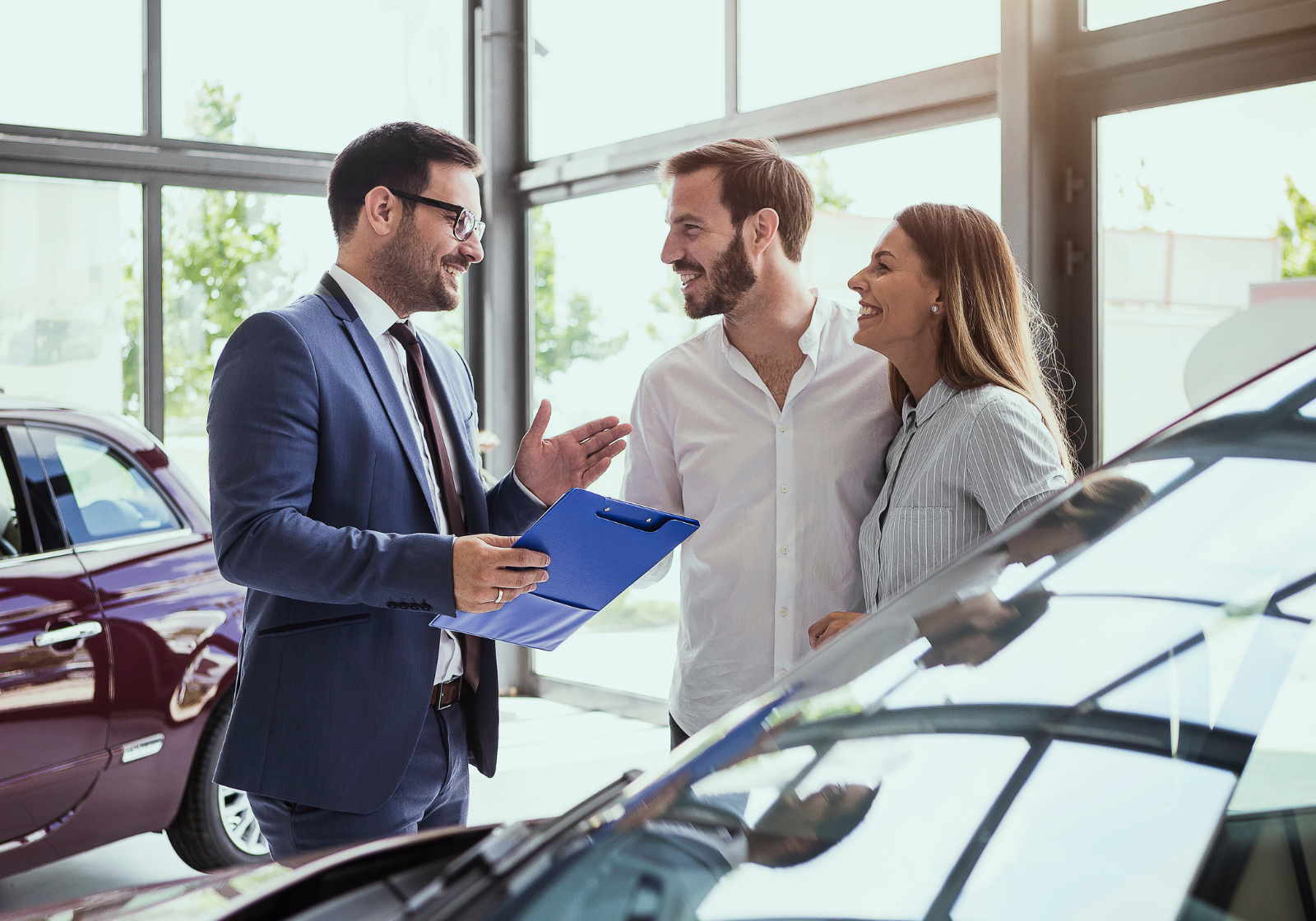 A couple at a dealership buying a car