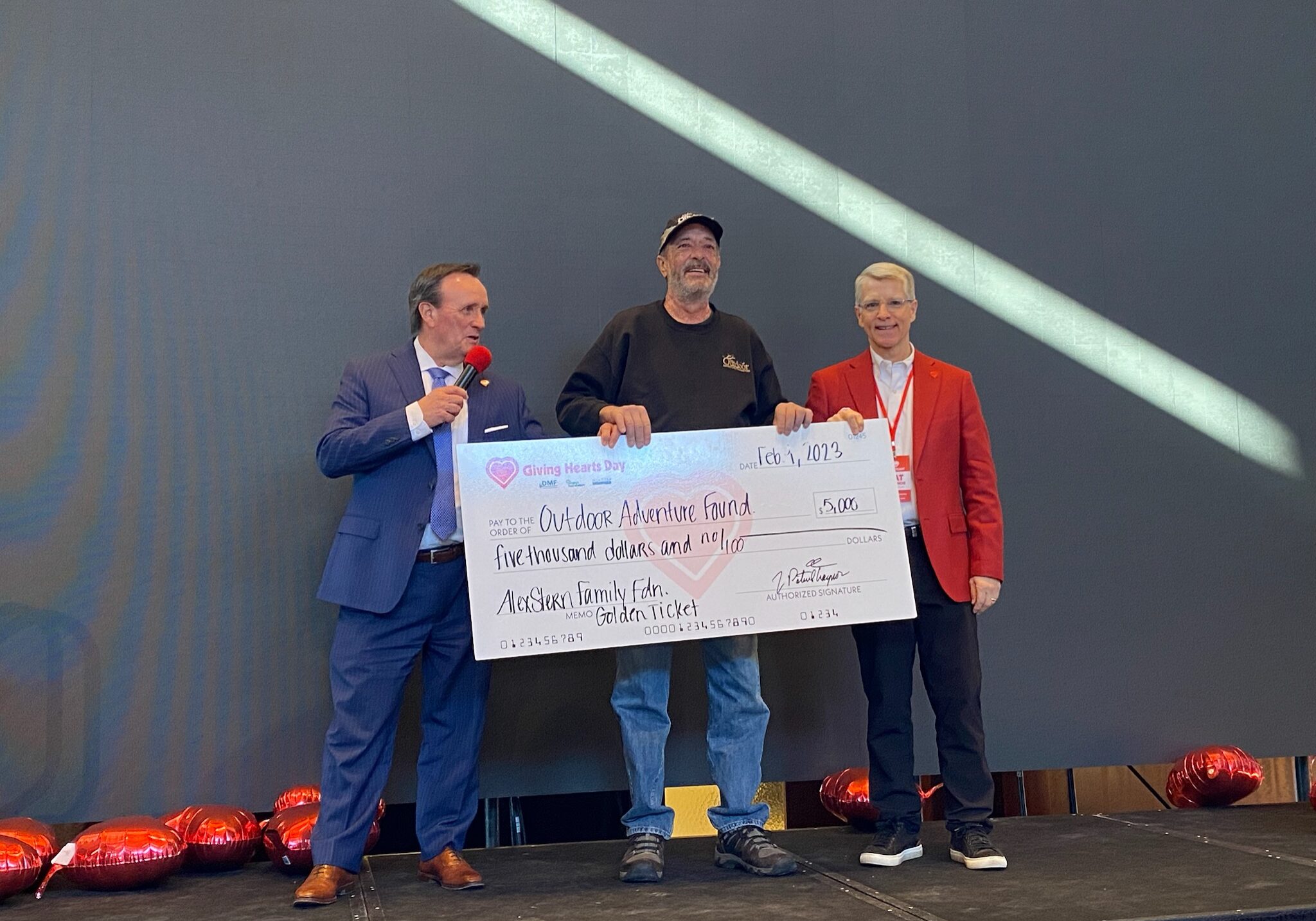 Dan Carey presenting a check at GHD