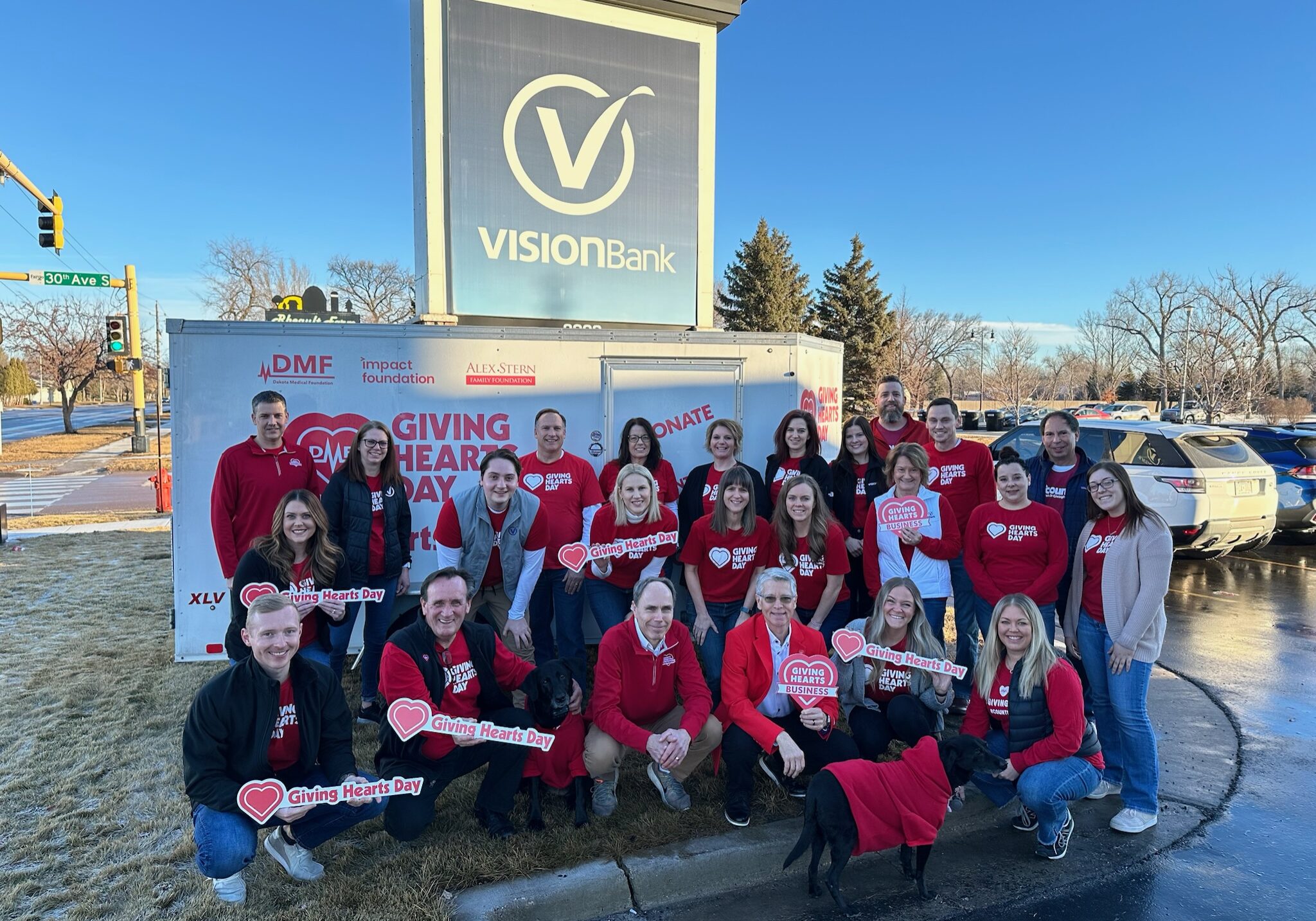 Group picture featuring VISIONBank team members dressed up for Giving Hearts Day