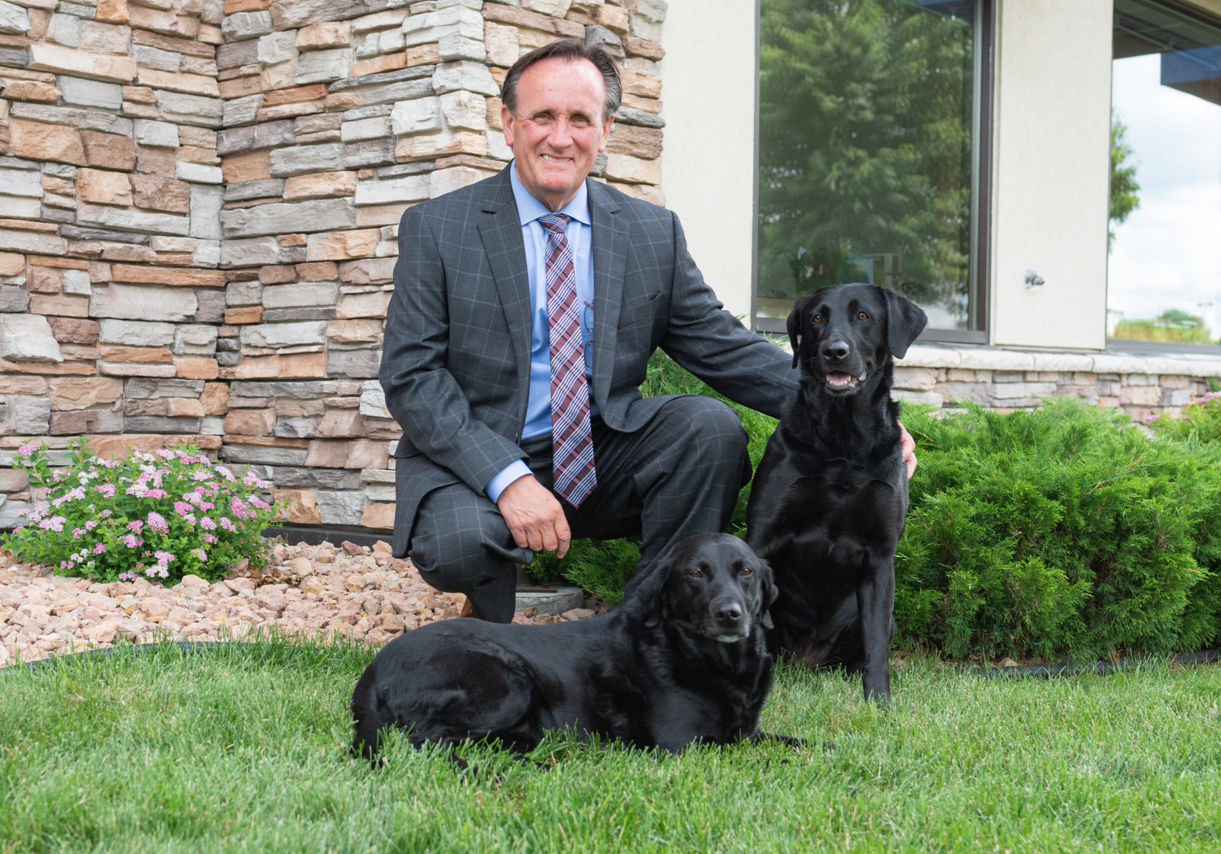 Dan Carey outside of VISIONBank with Scout and Piper